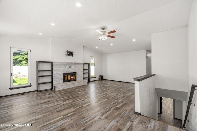 3623 W Hillcrest Cir, Coeur Dalene, ID 83815 - unfurnished living room with plenty of natural light, a ceiling fan, vaulted ceiling, wood finished floors, and a fireplace