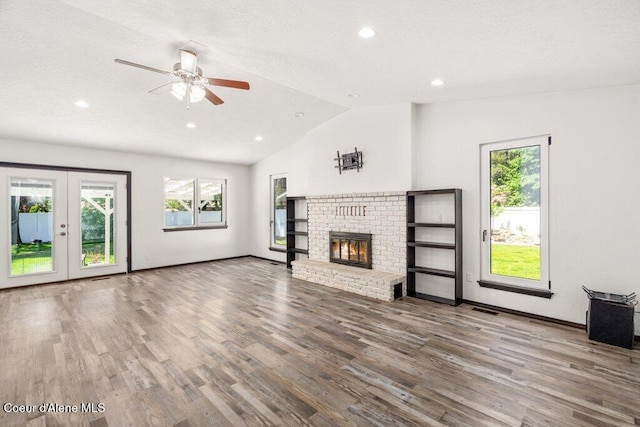 3623 W Hillcrest Cir, Coeur Dalene, ID 83815 - unfurnished living room with vaulted ceiling, healthy amount of natural light, wood finished floors, french doors, and a ceiling fan
