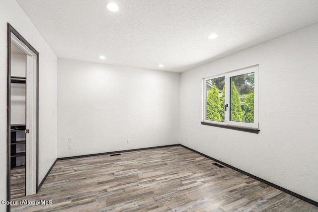 3623 W Hillcrest Cir, Coeur Dalene, ID 83815 - empty room featuring recessed lighting, wood finished floors, a textured ceiling, and baseboards