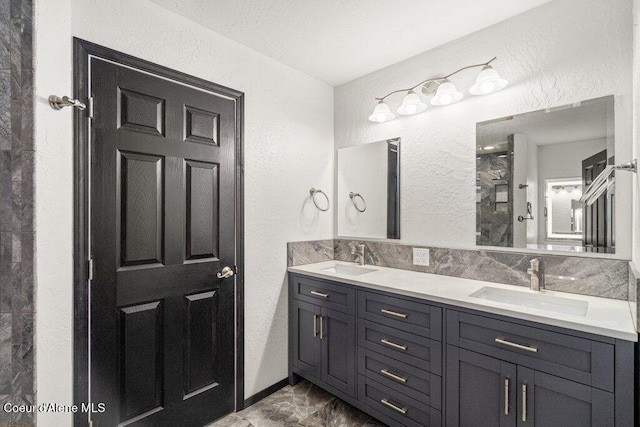 3623 W Hillcrest Cir, Coeur Dalene, ID 83815 - full bathroom with a textured wall, double vanity, marble finish floors, and a shower