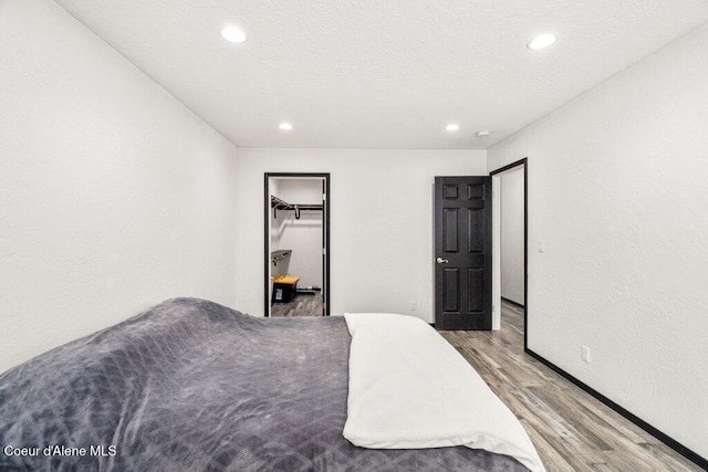 3623 W Hillcrest Cir, Coeur Dalene, ID 83815 - bedroom with wood finished floors, recessed lighting, and a closet