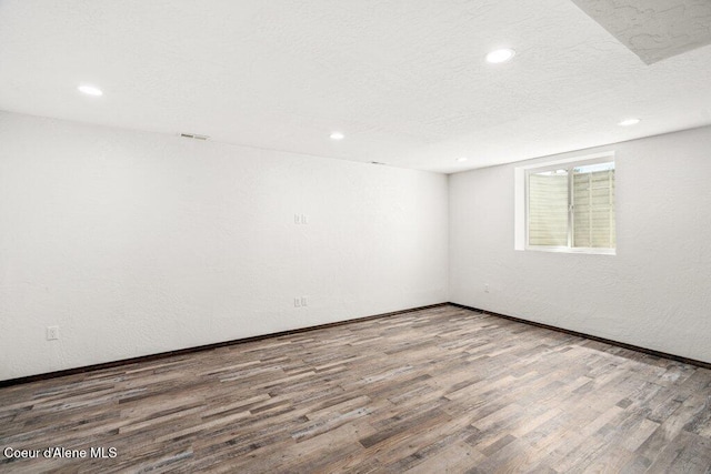 3623 W Hillcrest Cir, Coeur Dalene, ID 83815 - empty room with wood finished floors, recessed lighting, and baseboards