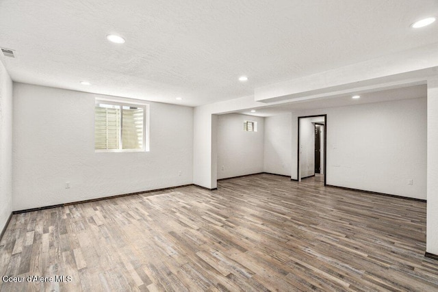 3623 W Hillcrest Cir, Coeur Dalene, ID 83815 - basement featuring recessed lighting, wood finished floors, a textured ceiling, and baseboards