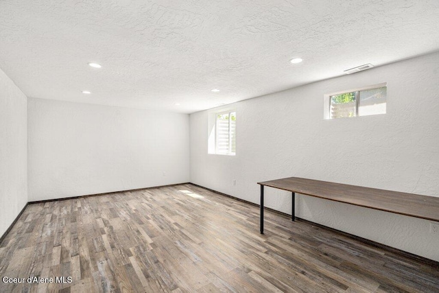 3623 W Hillcrest Cir, Coeur Dalene, ID 83815 - below grade area featuring a textured ceiling, wood finished floors, recessed lighting, a textured wall, and baseboards