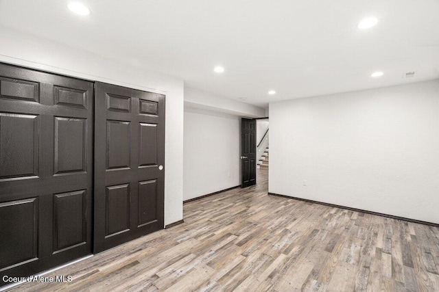 3623 W Hillcrest Cir, Coeur Dalene, ID 83815 - unfurnished room with light wood-style floors, stairs, recessed lighting, and baseboards