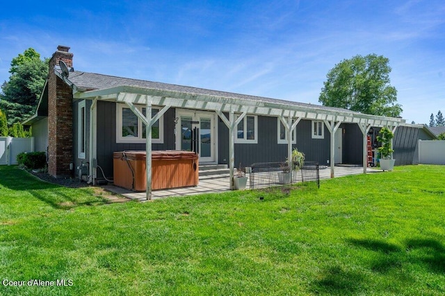 3623 W Hillcrest Cir, Coeur Dalene, ID 83815 - back of house with a hot tub, a patio area, and a chimney
