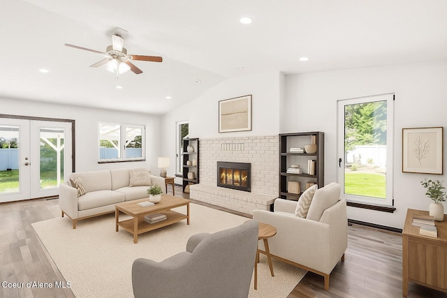 3623 W Hillcrest Cir, Coeur Dalene, ID 83815 - living area featuring vaulted ceiling, light wood-style floors, ceiling fan, a fireplace, and recessed lighting
