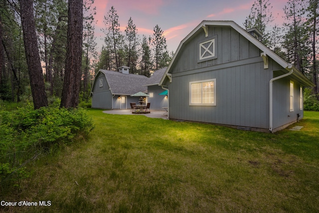 29808 N Caribou Ave, Athol, ID 83801 - back of house featuring an outbuilding, a lawn, a patio area, and a barn