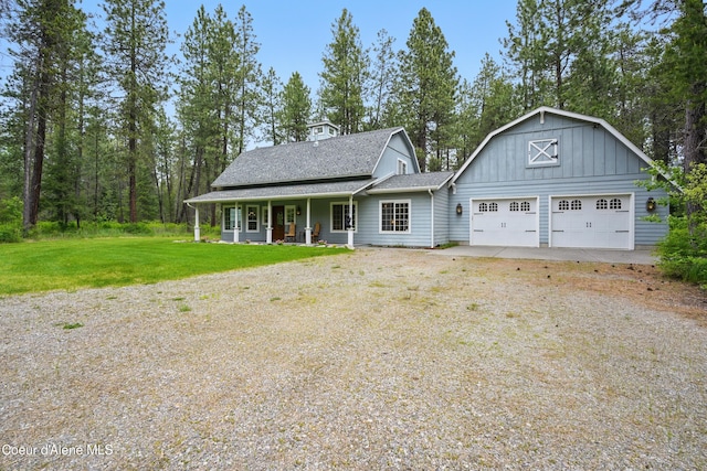 29808 N Caribou Ave, Athol, ID 83801 - view of front of house with covered porch, a front yard, dirt driveway, an attached garage, and board and batten siding