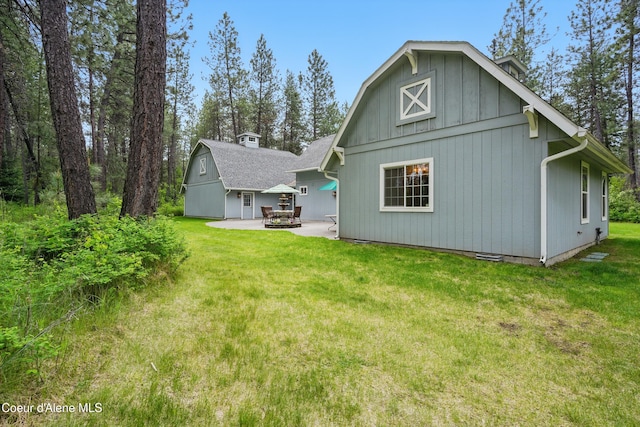 29808 N Caribou Ave, Athol, ID 83801 - back of property featuring an outdoor structure, a lawn, a patio area, and a barn