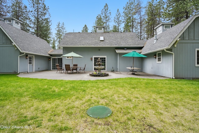 29808 N Caribou Ave, Athol, ID 83801 - rear view of house with a patio, a lawn, and a shingled roof