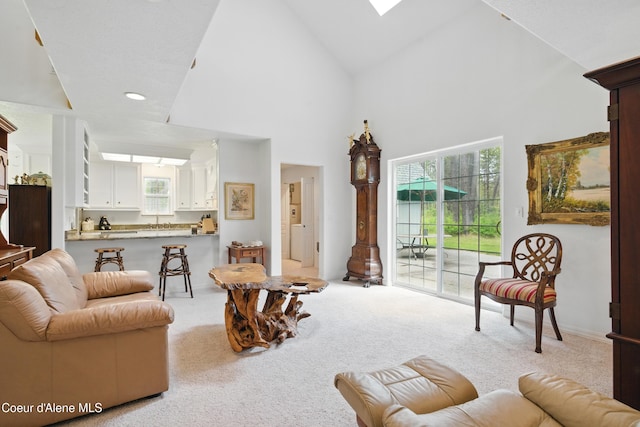 29808 N Caribou Ave, Athol, ID 83801 - living area featuring light carpet, healthy amount of natural light, high vaulted ceiling, and a skylight
