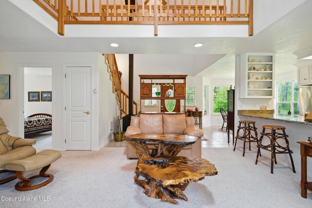 29808 N Caribou Ave, Athol, ID 83801 - living room featuring a high ceiling, stairway, light colored carpet, and recessed lighting