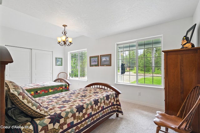 29808 N Caribou Ave, Athol, ID 83801 - bedroom with carpet, a chandelier, a closet, and a textured ceiling