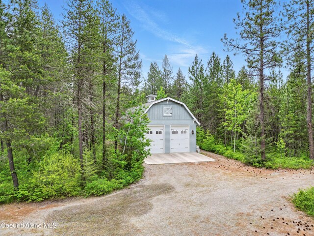 29808 N Caribou Ave, Athol, ID 83801 - garage with a detached garage and a view of trees