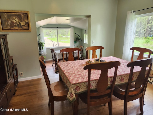 16488 N Atlas Rd, Rathdrum, ID 83858 - dining area featuring hardwood / wood-style floors, lofted ceiling, healthy amount of natural light, and baseboards