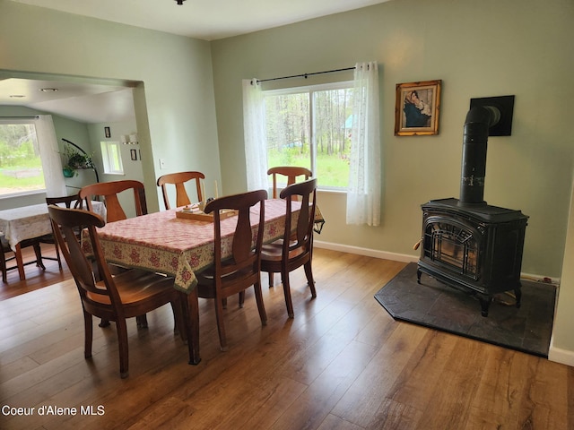 16488 N Atlas Rd, Rathdrum, ID 83858 - dining room with hardwood / wood-style floors, a wood stove, and baseboards