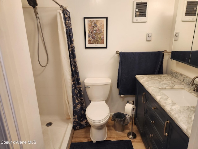 16488 N Atlas Rd, Rathdrum, ID 83858 - full bath with wood finished floors, vanity, toilet, and tiled shower