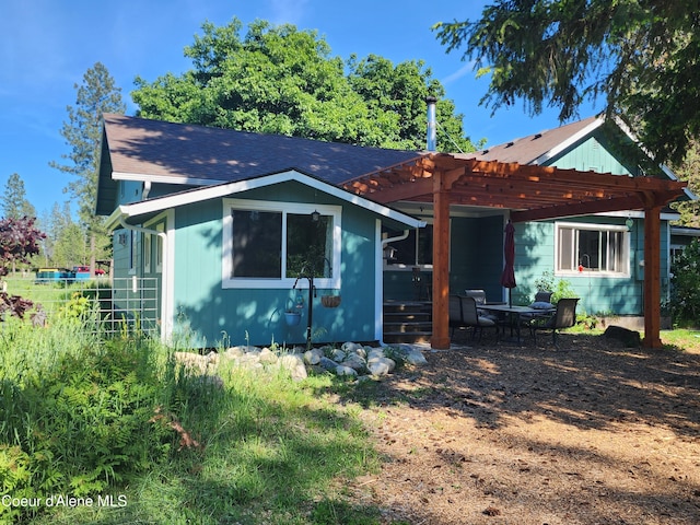 16488 N Atlas Rd, Rathdrum, ID 83858 - rear view of property featuring a pergola and roof with shingles