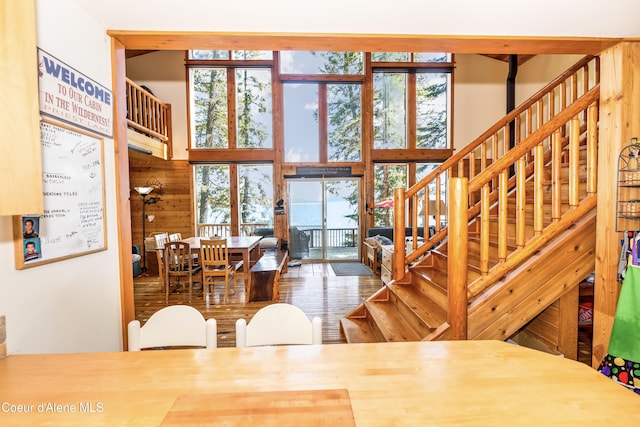 90 Bartoo Is Shr, Priest Lake, ID 83856 - dining space featuring a towering ceiling, stairs, and wood finished floors