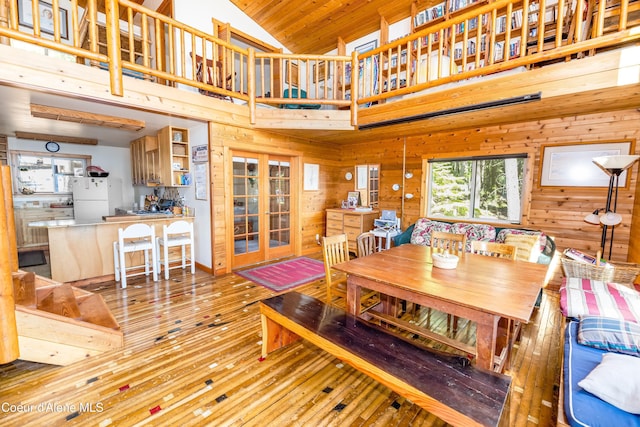 90 Bartoo Is Shr, Priest Lake, ID 83856 - dining room featuring hardwood / wood-style floors, wooden walls, french doors, and high vaulted ceiling