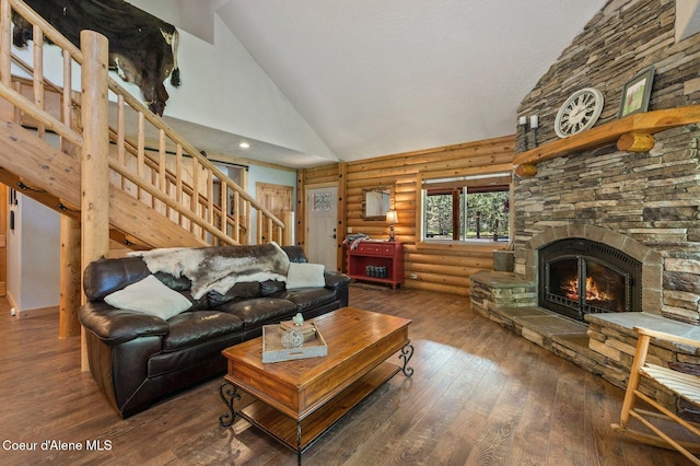 27294 N Clagstone Rd, Athol, ID 83801 - living room featuring high vaulted ceiling, log walls, stairs, wood-type flooring, and a stone fireplace
