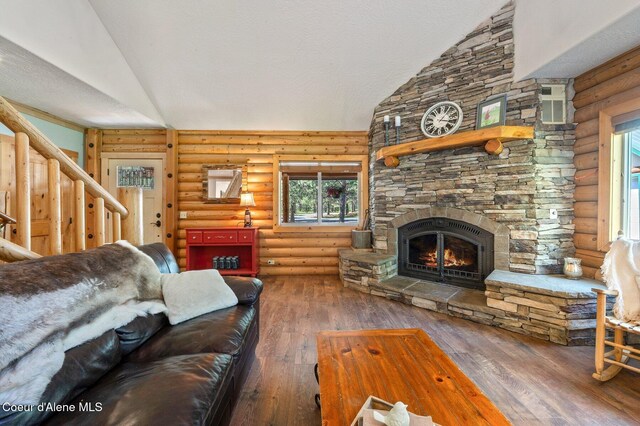 27294 N Clagstone Rd, Athol, ID 83801 - living area featuring a fireplace, hardwood / wood-style floors, high vaulted ceiling, and rustic walls