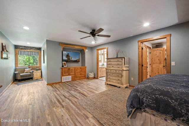 27294 N Clagstone Rd, Athol, ID 83801 - bedroom featuring wood finished floors, recessed lighting, baseboards, a ceiling fan, and ensuite bath