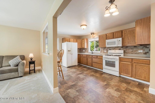 103 3rd St, Wallace, ID 83873 - kitchen featuring white appliances, decorative backsplash, light countertops, baseboards, and open floor plan