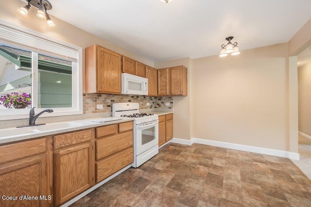103 3rd St, Wallace, ID 83873 - kitchen featuring white appliances, a sink, baseboards, stone finish floors, and light countertops