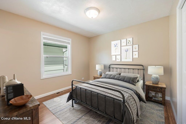 103 3rd St, Wallace, ID 83873 - bedroom featuring baseboards and wood finished floors