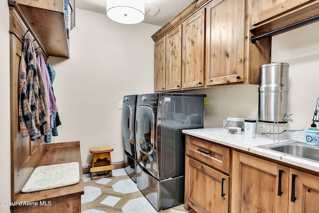 11690 N Arnicas Ct, Hayden, ID 83835 - laundry area featuring washer and clothes dryer, cabinet space, and light tile patterned floors