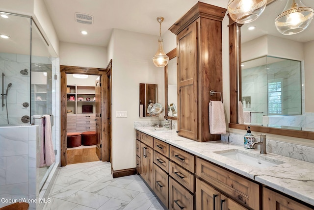 11690 N Arnicas Ct, Hayden, ID 83835 - bathroom featuring a stall shower, double vanity, marble look tiles, a walk in closet, and recessed lighting