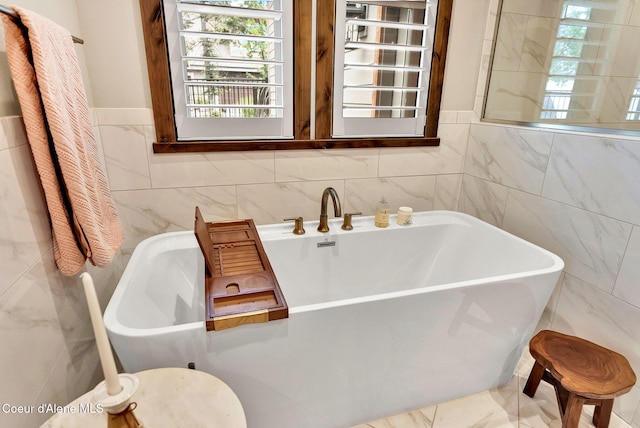 11690 N Arnicas Ct, Hayden, ID 83835 - bathroom with tile walls and a freestanding bath