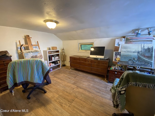 176 King St, Wallace, ID 83873 - bedroom featuring wood finished floors and vaulted ceiling