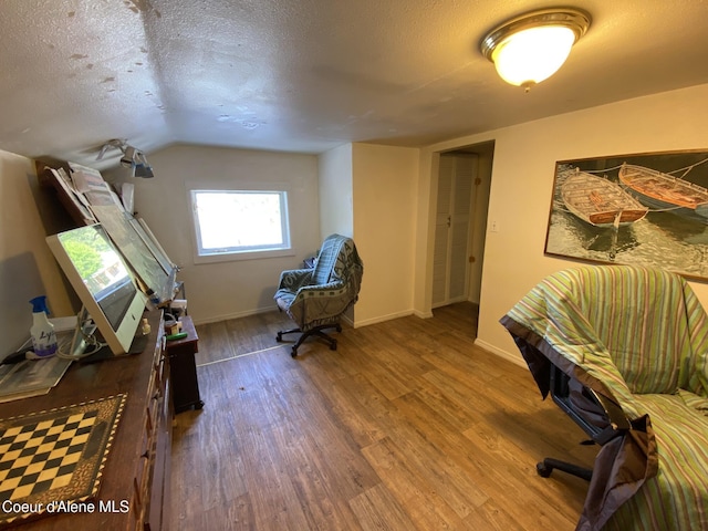 176 King St, Wallace, ID 83873 - office featuring wood finished floors, baseboards, a textured ceiling, and vaulted ceiling