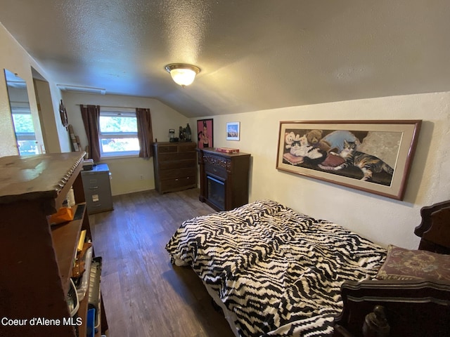 176 King St, Wallace, ID 83873 - bedroom featuring dark wood-style flooring, vaulted ceiling, and a textured ceiling