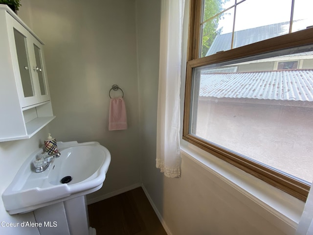 176 King St, Wallace, ID 83873 - bathroom with baseboards, wood finished floors, and a sink