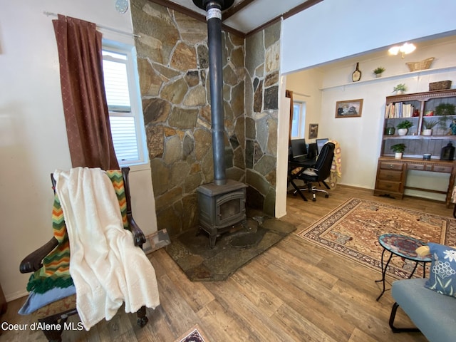 176 King St, Wallace, ID 83873 - living area with a wood stove, wood finished floors, and baseboards