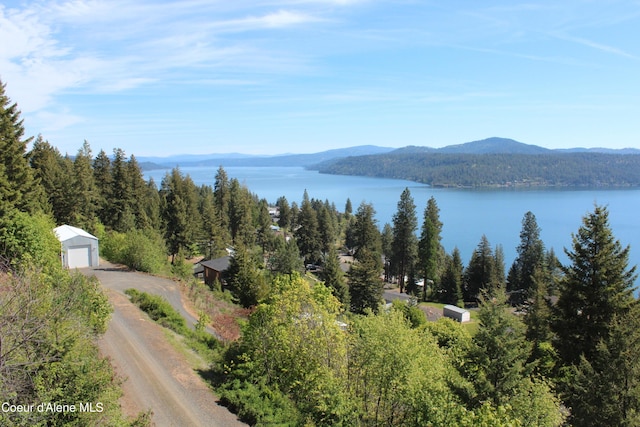 22884 S High Dr, Worley, ID 83876 - water view featuring a mountain backdrop and a heavily wooded area