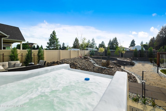11387 N Armonia Way, Hayden Lake, ID 83835 - fenced backyard featuring a patio area and a vegetable garden