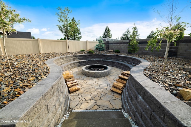 11387 N Armonia Way, Hayden Lake, ID 83835 - fenced backyard featuring an outdoor fire pit and a patio