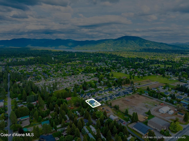 11387 N Armonia Way, Hayden Lake, ID 83835 - aerial view of property and surrounding area with a mountain backdrop and property boundaries highlighted