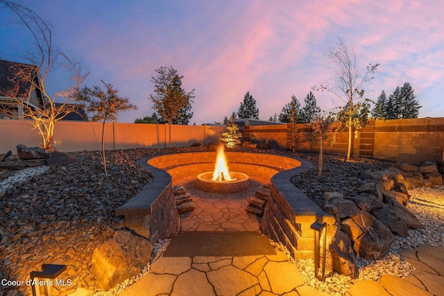 11387 N Armonia Way, Hayden Lake, ID 83835 - fenced backyard featuring an outdoor fire pit and a patio area