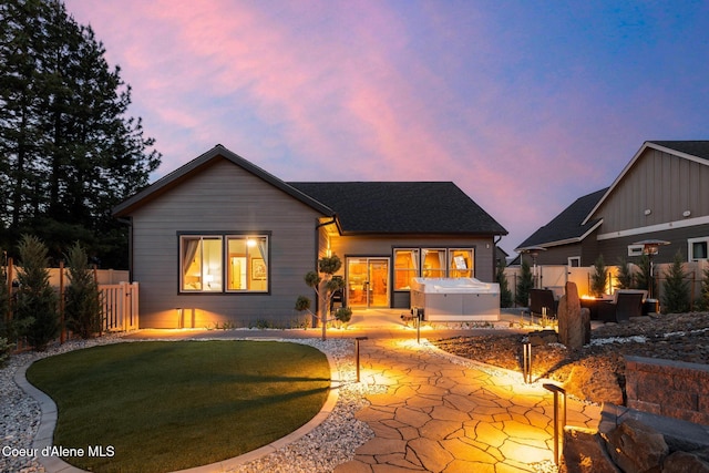 11387 N Armonia Way, Hayden Lake, ID 83835 - rear view of house with a patio area, an outdoor fire pit, and a hot tub