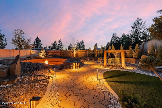 11387 N Armonia Way, Hayden Lake, ID 83835 - fenced backyard with a fire pit and a patio area