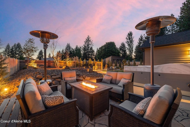 11387 N Armonia Way, Hayden Lake, ID 83835 - fenced backyard featuring an outdoor living space with a fire pit, an outdoor structure, and a patio area