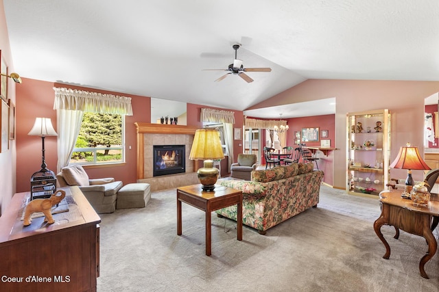 3391 W Loxton Loop, Coeur Dalene, ID 83815 - living area with a ceiling fan, light carpet, vaulted ceiling, a tiled fireplace, and a chandelier