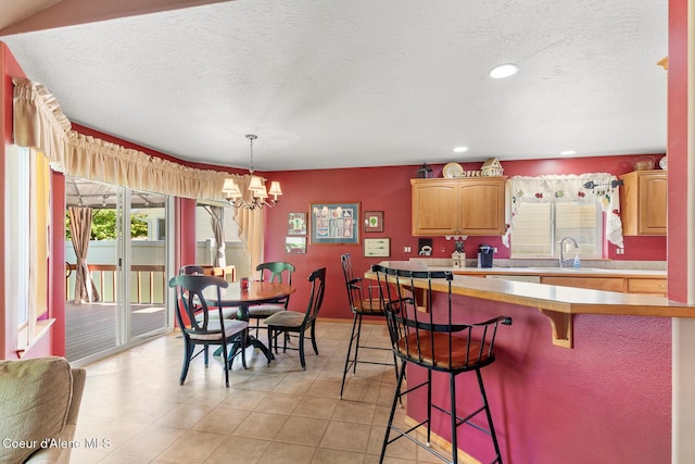 3391 W Loxton Loop, Coeur Dalene, ID 83815 - dining room with a chandelier, a textured ceiling, recessed lighting, light tile patterned flooring, and baseboards