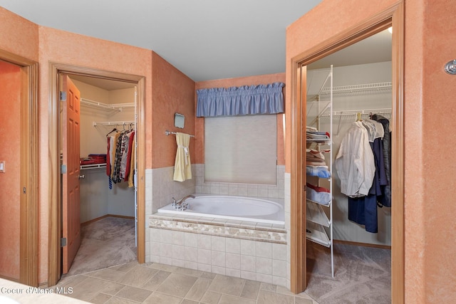 3391 W Loxton Loop, Coeur Dalene, ID 83815 - bathroom with a garden tub, a walk in closet, and baseboards